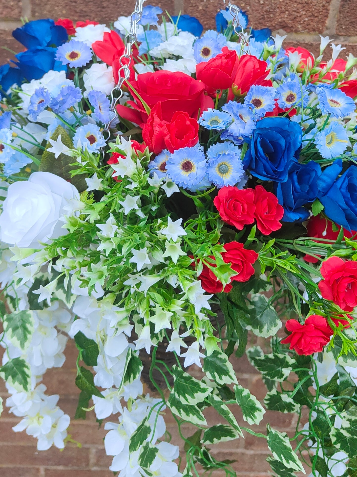 Red white blue artificial flowers hanging basket outdoor