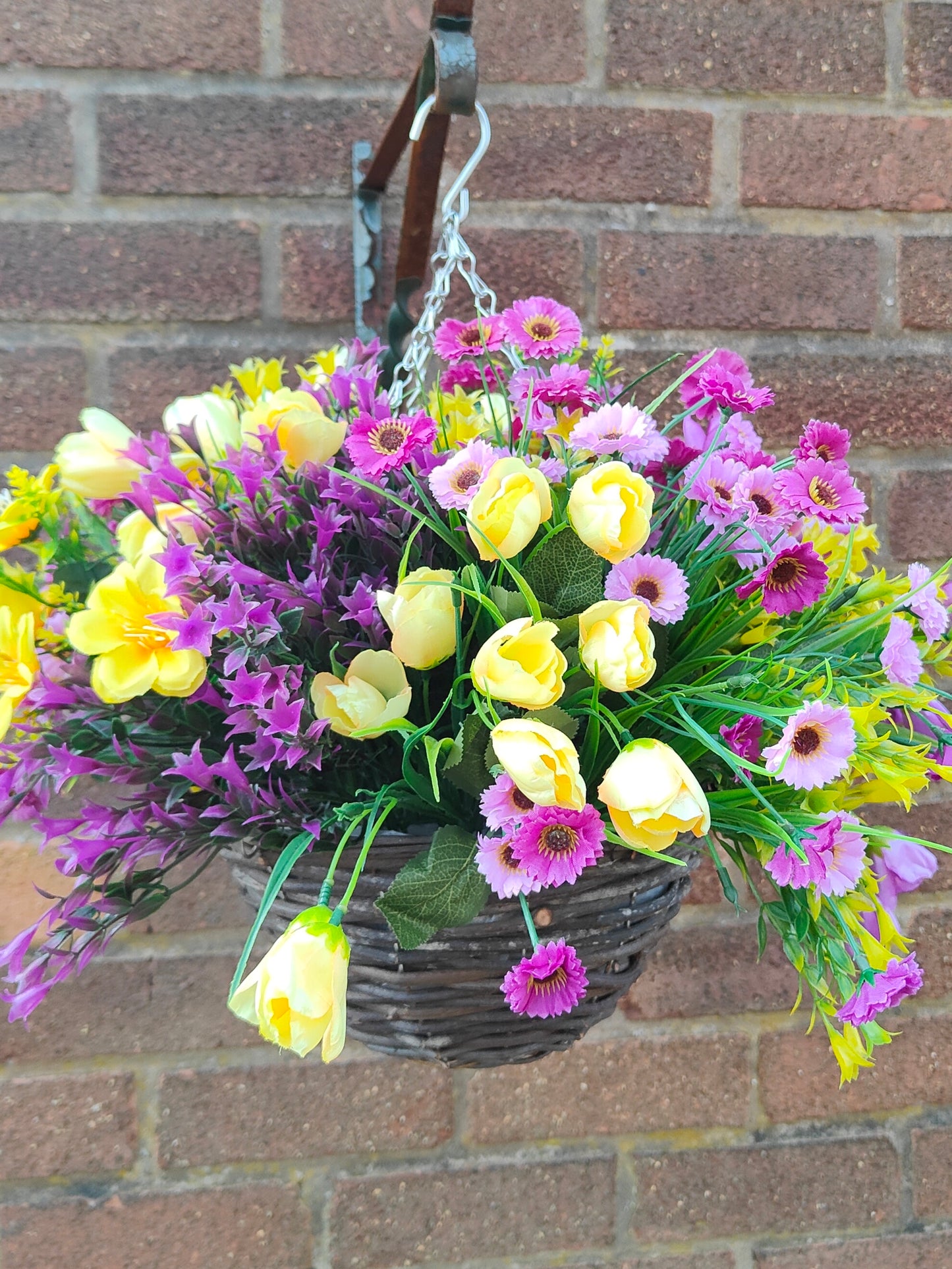 Purple yellow artificial flower hanging basket pub